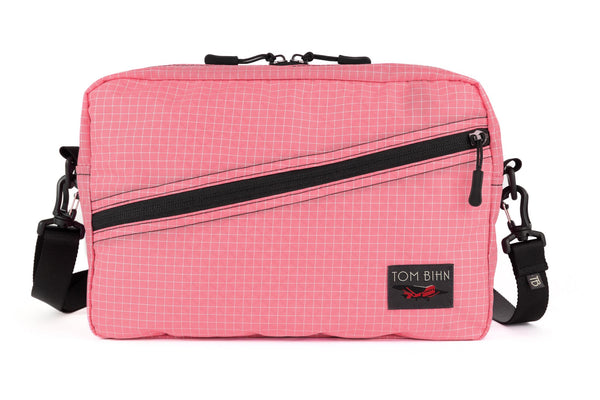 A Packing Cube Shoulder Bag in Sakura (pale pink with white grid) 200 Halcyon with a 1-inch shoulder strap attached